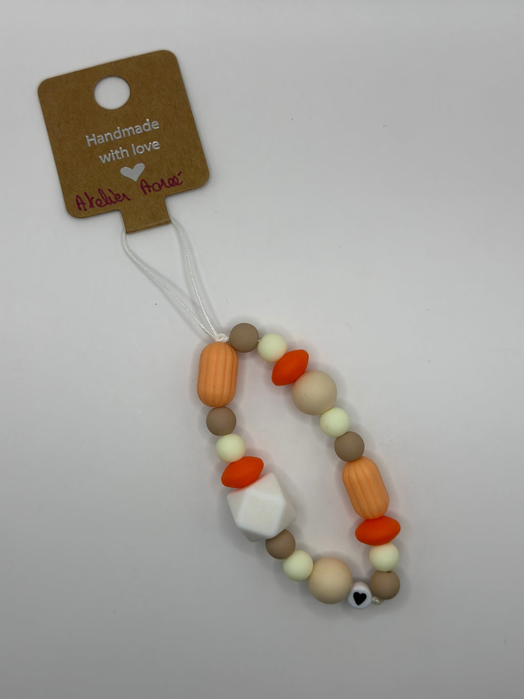 Détail bijou cordon artisanal couleurs ensoleillées fait main France 